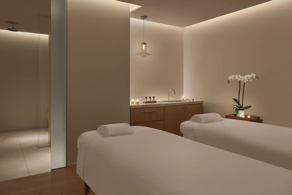 Luxury hotel indoor thermal pool spa with stone walls — search: luxury hotel spa indoor thermal pool stone walls